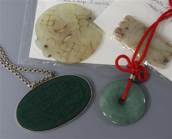 An oval jade plaque with Arabic inscription on silver (925) chain and three other jade items,